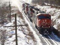 I’m not a big fan of shooting into the sun but I couldn’t resist the rare chance to photograph CN 431 in daylight today as it races away from fast approaching lake affect snow squalls just east of Guelph. Today’s consist is a pair of SD75’s bracketing a Dash 9 as the train is about to duck under Jones Baseline Road. 
