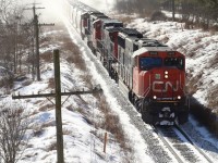 I’m not a big fan of shooting into the sun but I couldn’t resist the rare chance to photograph CN 431 in daylight today as it races away from fast approaching lake affect snow squalls just east of Guelph. Today’s consist is a pair of SD75’s bracketing a Dash 9 as the train is about to duck under Jones Baseline Road. 