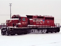 The rain is starting to wash off the earlier snowfall from SD40-2 5916. Note the icy moisture on the cold empty fuel tank.