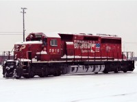 The rain is starting to wash off the earlier snowfall from SD40-2 5916. Note the icy moisture on the cold empty fuel tank.