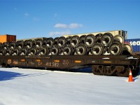 Vintage CP flat car with a load of new rail car wheel sets.