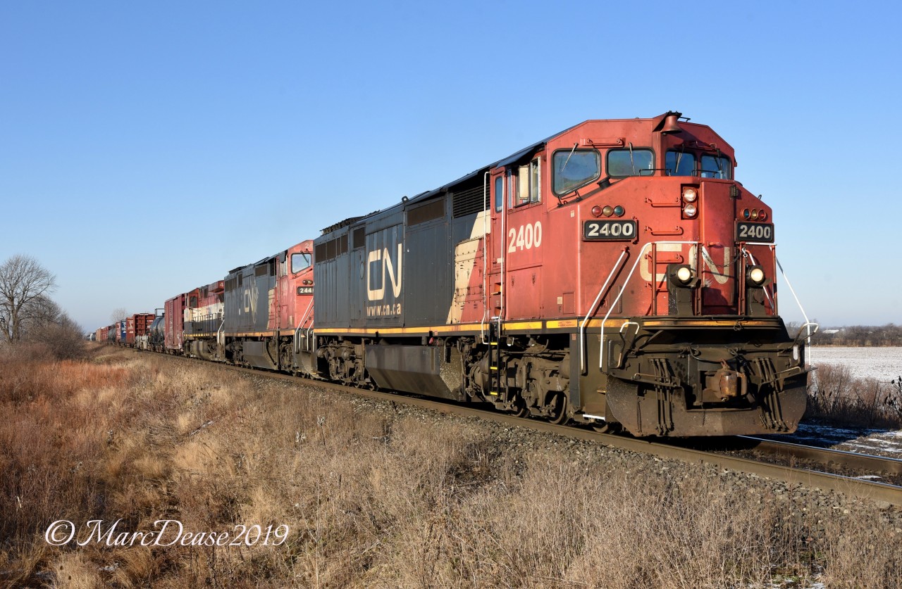 Double CN cowls leading and BCOL trailer made this a photographers dream as 394 heads east out of Sarnia, ON., at Fairweather Sideroad.