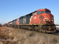 Double CN cowls leading and BCOL trailer made this a photographers dream as 394 heads east out of Sarnia, ON., at Fairweather Sideroad.