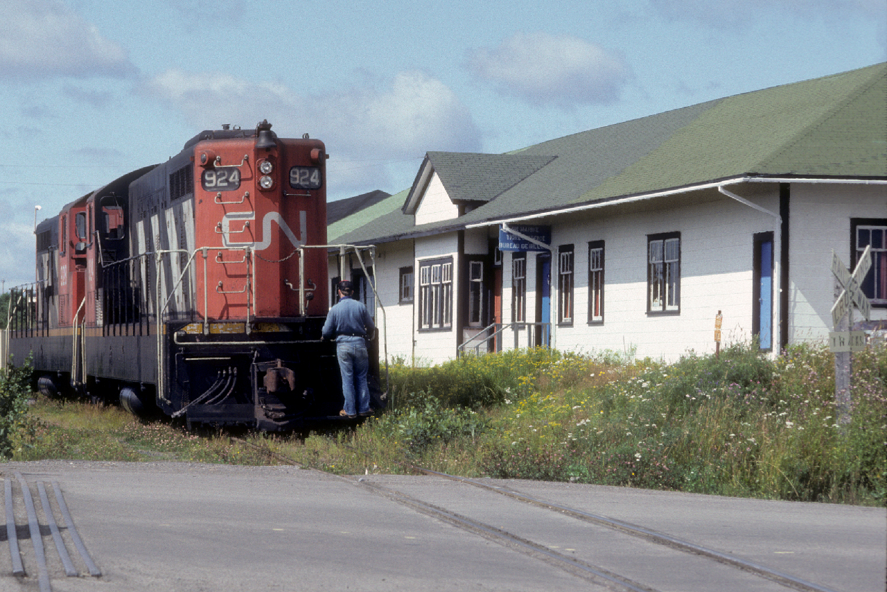Canadian National 1200 hp NF210s 924 and 928 pull by the station in Lewisporte, Newfoundland on Friday, August 27, 1982.  The units had left Bishops Falls that morning as Extra 928 with a train of empty pulpwood cards and a handful of boxcars for Lewisporte.  At Notre Dame Jct., Mileage 244.5, they set off the pulpwood empties which they would deliver to the loading grounds at Glenwood some nine miles to the east on the Clarenville Subdivision.  In the meantime, the units traversed the 9.4-mile Lewisporte Subdivision.  Upon arrival they wyed their train and proceeded to switch the docks where CN Marine's PETITE FORTE, the KLOSTER and the MARINE TRADER were loading for various outports.  The Lewisporte Sub boomed from the late 1930s through the 1960s as the inbound port for materials and aviation fuel that was shipped to the nearby Gander airport.  Previously Lewisporte had served as a staging area for the construction of the paper mill in Windsor from 1906 through 1909. Light, 50 lb rail required the used of 2-8-0s until the CNR relaid the line with 70 lb rail after 1949.  As traffic dwindled in the late 1970s the line was downgraded to a spur with intermittent traffic until it was abandoned in 1987.  Formerly the line hosted weekday Trains 909 and 910 from Bishops Falls.  Unit 924 became the last unit to run in Newfoundland with engineer Brendan Dicks at the throttle when it was placed on display in Bishops Falls on Wednesday, November 21, 1990.  NF 928 went to Nicaragua and later Chile for further operation.  NF110 902 is displayed in Lewisporte.  For further views of Lewisporte and throughout "The Rock" please contact me at bill.linley@gmail.com about my forthcoming MOrning Sun book: "Trackside Newfoundland,"