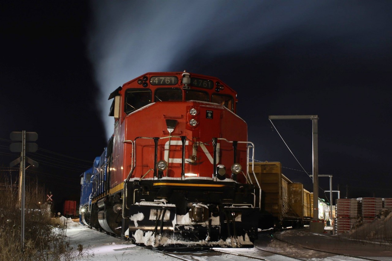 The smell of diesel exhaust hangs heavy in the air at Preston as GMTX 2274 idles away trying to maintain its internal temperature on a bitterly cold night. With a wind chill of almost -30 it’s prime mover won’t get much of a break before the mornings call to duty. In the background a worker is busy unloading the last two cars of wallboard before the local lifts the cars in the morning and takes them to Guelph with the cut of cars on the main in the distance.