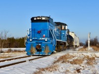 Pushing over the slightest snowhill (previously made by a snowplow) and creating a bit of snow dust, GMTX 333 crosses over Station st in Caledon as it makes its southbound trip to Mississauga on a beautiful sunny winter morning. Time was 09:09