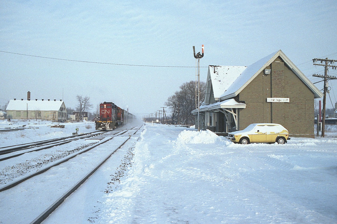 With the recent chatter about the upcoming demise of the old Ingersoll, Ontario CN station, I felt it appropriate a time to dig up a shot of the structure in somewhat better years.  Even 37 years ago there is not much evidence of activity as a westbound passenger train roars by. The locomotive assigned on this particular move is CN 4423. For some reason I just cannot seem to recall any GP9s of the 4400 series on passenger assignment. For me an unusual sighting on what was one bitter cold January day.