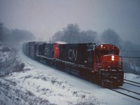 In a raging snow storm, CN C630m units 2001 and 2008 lead a westbound freight under the Plains Road bridge and into Bayview. Note the location of the horns and behind the cab on the engineer's side; the 2001 and 2000 were also the only CN C630m units with delivered with dynamic brakes.