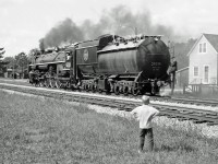 <B>Never seen one of these before! </B> A young boy looks on as CN 6218 passes by on her own.  I believe she was heading for a location to turn the engine.  This photo is circa 1965.  Any help with the location and date would be appreciated.  Might be Stratford as the next pictures that I took were in Brantford.  