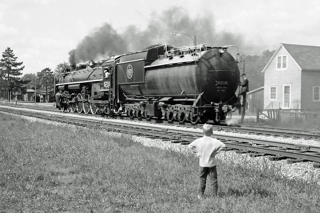 Never seen one of these before!  A young boy looks on as CN 6218 passes by on her own.  I believe she was heading for a location to turn the engine.  This photo is circa 1965.  Any help with the location and date would be appreciated.  Might be Stratford as the next pictures that I took were in Brantford.