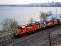 CP SD40 5555 and "Empress of Agincourt" RSD17 8921 handle an eastbound freight (probably the Starlight from Abderdeen Yard) coming off CP's Hamilton Sub at Hamilton Junction, operating via running rights over CN's Oakville Sub to Canpa. The downtown Hamilton skyline can be seen at the other end of Burlington Bay.