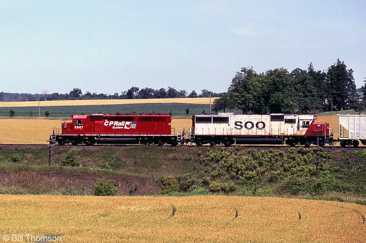 CP SD40-2 5587 & SOO SD60 6001 lead a westbound past farmer's fields at Lobo, on CP's Windsor Sub just west of London.