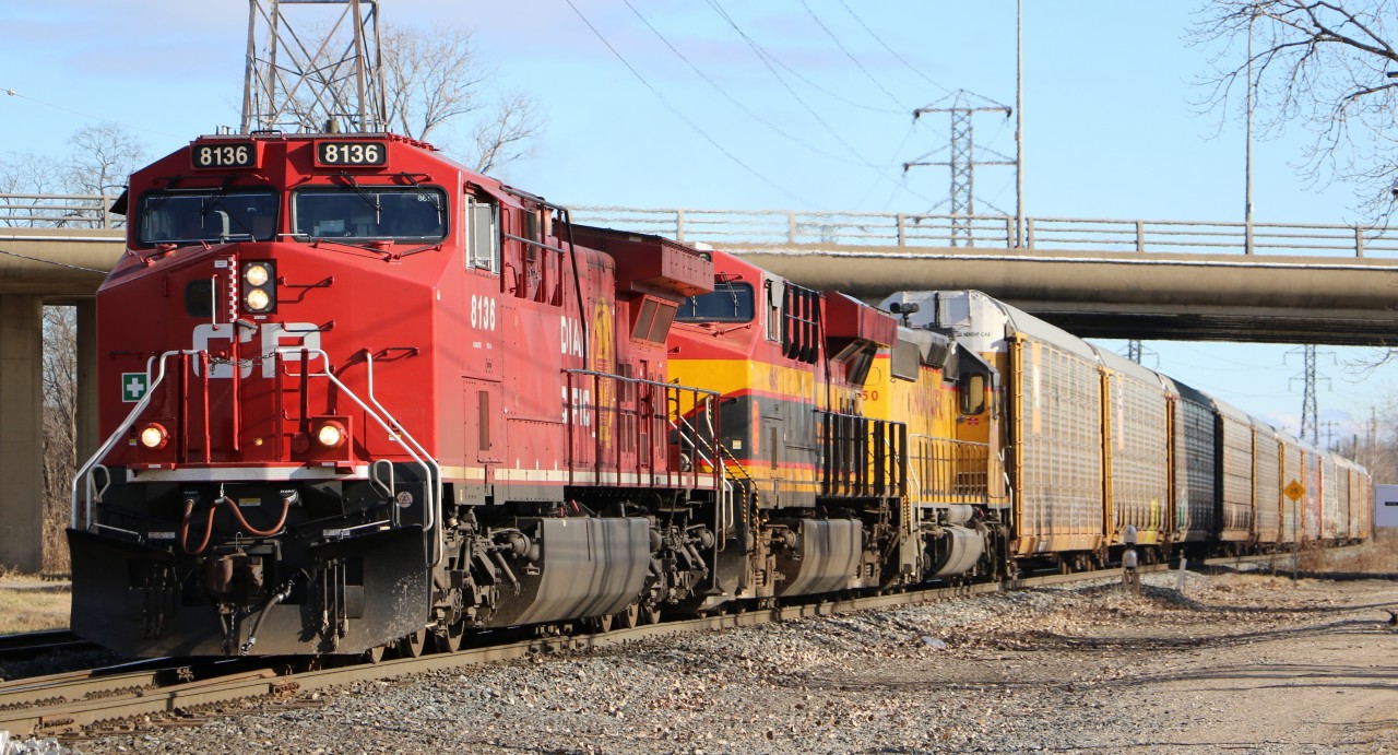CP 141 heads west at Dougall Ave in Windsor with a colorful lashup.