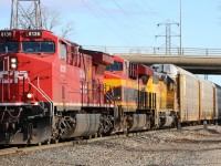 CP 141 heads west at Dougall Ave in Windsor with a colorful lashup.