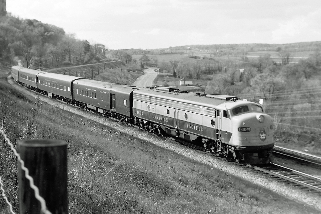 Passenger service on the Galt Sub with an E8?  Well, not really.  This was a fan trip that originated at the Hunter St. station in Hamilton.  If I remember correctly, we ran up what is now the Hamilton Sub. to Guelph Jct. then turned east on the Galt Sub.  The runpast  location is near Kelso park.  Hwy 401 can be seen in the background.
