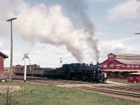 In the latter part of the 1950s, in the Upper Ottawa Valley community of Pembroke, Ontario, Stephan Delmonte (Del) Rosamond made a point of being trackside to photograph steam locomotive operations on Canadian Pacific Railway at a time when the Company was transitioning away from venerable steam power to modern diesel-electric locomotion.  The accompanying two photographs were archived during this time period.

<br>
<br>

On what appears to be a pleasant spring day, circa 1956-57, Del is on location near the downtown CPR station, as the Chalk River to Smiths Falls wayfreight makes a switch move in front of the Consolidated Paper and Lumber Company mill located on the south shore of the nearby Ottawa River.  Today's motive power is G1s class 4-6-2 Light Pacific No. 2219.  The engine, one of 39 coal fired G1's operated by the CPR, was out-shopped in February 1910 by Canadian Pacific's Angus Shops in Montreal, and has been modernized over the years.  According to the late Duncan H. du Fresne - who fired this class of locomotive - the engine received a new boiler and cylinders during a 1924 rebuild, and has been fitted-out with a modern cross compound air compressor.  In 1950 it became one of three G1 class 2200s to receive a Standard HT-1 Stoker, with the other 36 remaining hand-fired coal burners.  At the time of the stoker installation the engine was paired with a 14 ton/8000 Imperial gallon capacity tender.  Duncan would later write in his book titled 'When Steam and Steel get in your Blood' that “the upgrade made them into super G1's... much like the modern G5's".

<br>
<br>

Engine No. 2219 saw service in Eastern Ontario well into 1960, and was disposed of by Canadian Pacific in July 1961.  The locomotive was likely scrapped shortly thereafter.
<br>
<br>
Original digital scanning provided by DigMyPics in Arizona.
<br>
<br>
Additional Photoshop restoration by Raymond Farand.
<br>
<br>
Research and narrative courtesy of Raymond Farand.