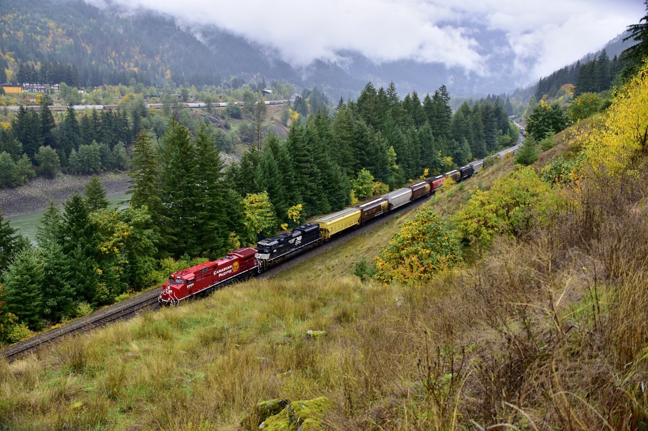 Re-built CP 8006 & NS 1158 are coasting into North Bend in charge of an eastbound load of grain empties. CN's Boston Bar yard can be seen on the other side of the Fraser River.