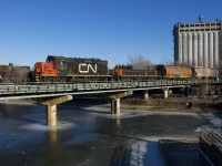 The Pointe St-Charles switcher has just two cars for the Port of Montreal as it crosses the frozen Lachine Canal with CN 7233 & CN 227 for power.