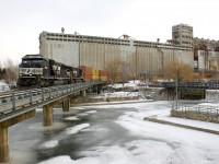 NS 6982 & NS 9194 lead 4,000 feet worth of stacks into the Port of Montreal as CN 543 passes in front of the out of use grain elevator #5 on a frigid afternoon.
