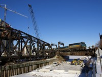 Preparatory work for the REM (Réseau express métropolitain) light rail project has begun where it will parallel CN's St-Hyacinthe Sub. Here VIA 67 with VIA 6413 leading crosses the Lachine Canal, with work ongoing underneath.