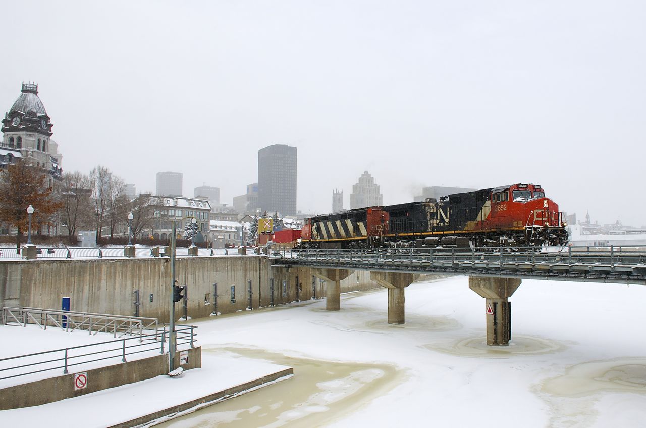 A late CN 149 is crossing the Lachine Canal with CN 2652 & CN 2409 for power on a frigid day after Montreal received a large snowstorm.