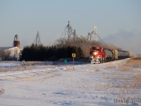 With OCS clearance in hand from Mile 12 to Gretna Spur Track Switch with a protect against one foreman, "The Altona", CP 2313 West rolls due south (timetable west), clearing the "Perimeter Highway" enroute to Altona, Manitoba. On a clear prairie day where the mercury is hovering around -30C a trail of exhaust hangs in the air as the crew navigate the last few miles of non-Main Track territory. Shortly they would be notching up to track speed (30 MPH), however the Rule 43 green flag protecting a slow order right at the begin/end main track will hamper their efforts for getting up to track speed.