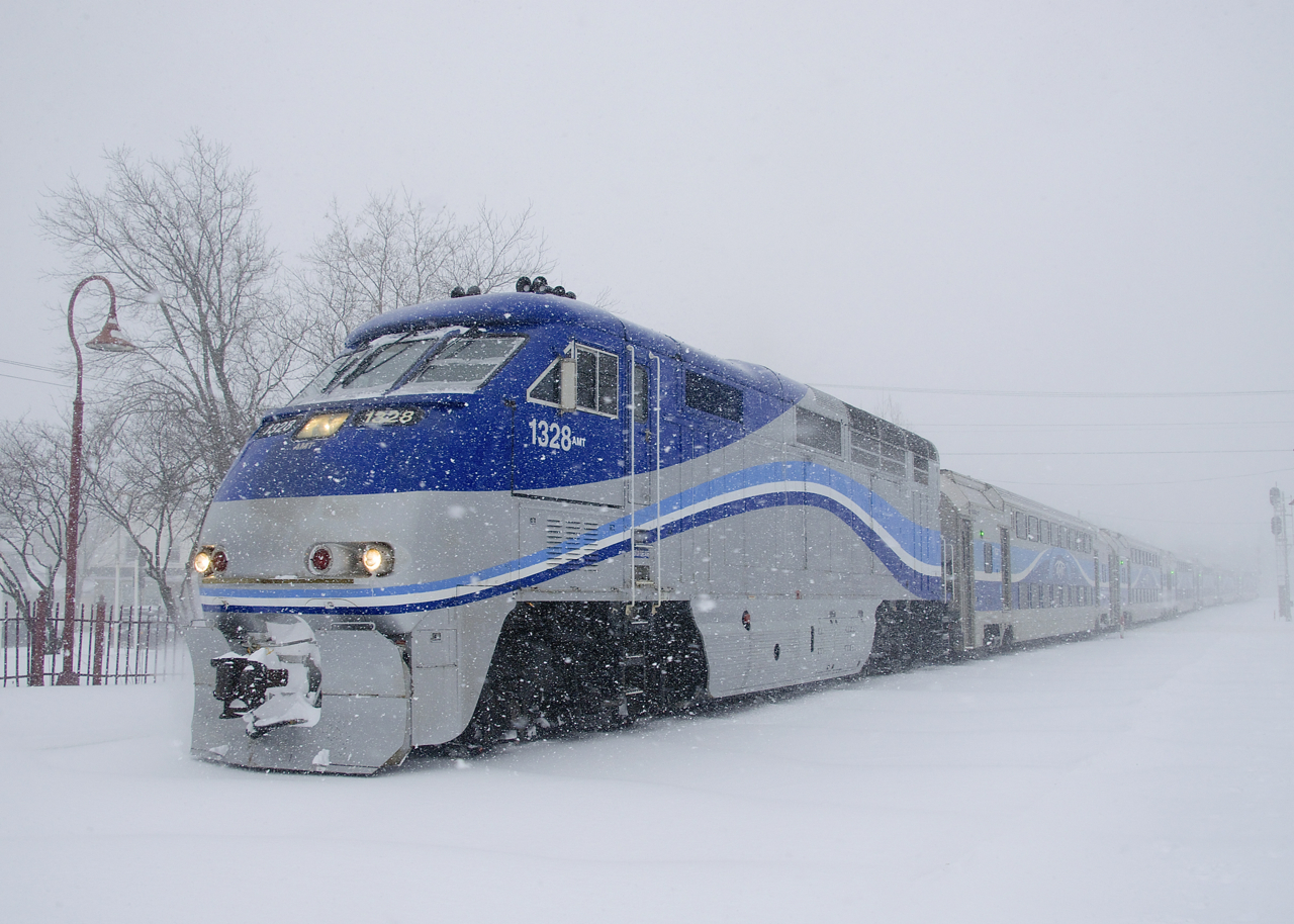 In the midst of a windy snowstorm, AMT 1328 leads EXO 60 into Montreal West Station. As all rolling stock is being rebranded EXO, the AMT logos that were once on the long hood of the locomotive have been removed. Interesting enough, a small 'AMT' has added to the right of the unit number, as AMT is still the reporting mark in use.