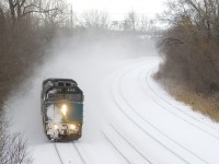 Snow-covered VIA 6406 leads VIA 34 from Ottawa around a curve as it heads east.