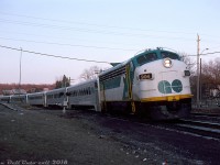 With a wave from one of the head-end crew, GO Transit APCU 904 (former Ontario Northland FP7 1513 rebuilt as a cab car/HEP generator) rounds the bend leading a string of single level Hawker Siddeley coaches and GP40-2W 703 through Campbellville at daybreak, deadheading with Milton line train #350 from the Guelph Jct layover yard to Milton Station. Given the train involved, this shot was likely taken sometime just after 6am as #350 was the first morning Milton line train of the day. According to the timetable schedule, upon arrival at Milton Station and taking on passengers, #350 would depart at 6:30am and after making stops along the line eventually arrive at Union Station in Toronto at 7:35am.<br><br>The GO Milton line had come into existance only a few months before in October 1981 as an effort to expand service to the growing Halton & Peel suburbs along Highway 401, and also to offer a closer alternative to commuters in those areas than driving down to the Lakeshore West line. The Milton line started out as a rush-hour commuter service into Toronto in the mornings (trains #350, 352 & 354) and out in the evenings (#351, 353 & 355). Not much has really changed due to CP's ownership of the tracks, except having a few more rush-hour trains and extra station stops added on the line. GO now runs buses off-peak, and has been adding extra bilevels to its trains in a effort to increase capacity (the Milton line was the first to get L12's back in 2008).<br><br><i>Reg Button photo, Dan Dell'Unto collection.</i>
