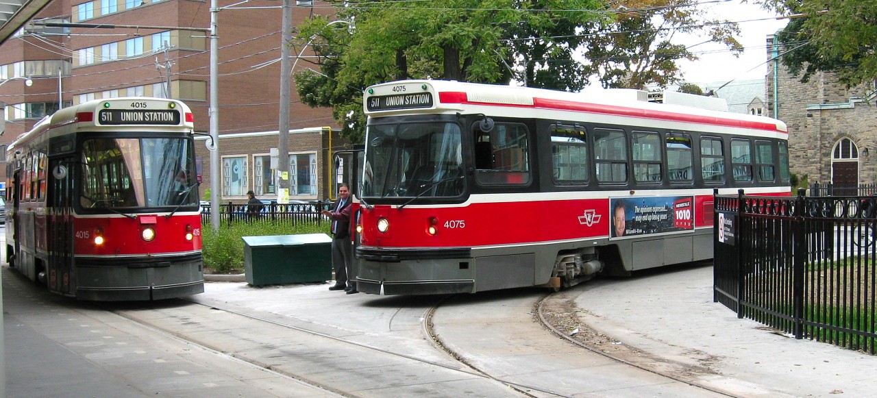 BATHURST STATION STOP. On my first Father-Son trip to Toronto in 2007 with my youngest son Thomas to watch our beloved Maple Leafs, we decided to experience their famous streetcars. Upon learning we had traveled all the way from Newfoundland & Labrador, a kind and generous TTC employee gave us a free return ticket to enjoy the 511 Route from Union Station to Bathurst. An added bonus, besides travelling through Kensington Market and Chinatown was that after the layover, the car was supposed to return empty to Union but with the exception of my son and I. What an amazing and wonderful experience we shared with the driver that afternoon, thanks to the wonderful TTC staff!Here, CLRV 4075 waits on the turn before allowing 4015 to proceed. Both of these Class L2 cars were 2 out of a group of 190 built for the TTC between 1977 and 1981. This Fall, I plan to release my third 'then & now' book, this time on the streetcars of St. John's.
