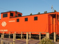 HOLYROOD MARINA MARKER. Former Canadian National caboose 6065 has been beautifully restored to its Terra Transport colour and markings by the Town of Holyrood and placed in a prominent location at their scenic marina. Caboose 6065 was one of a group of 5 built for Newfoundland service in 1965. The shell was built by National Steel Car in Hamilton, Ontario,and the interior was completed by CN at its Pointe St. Charles Shops in Montreal. It was shipped to North Sydney on its own wheels (a temporary set of standard gauge wheels). It crossed the Gulf as a deck load and was placed on narrow gauge wheels at Port aux Basques.
It was used in general freight train service by CN and Terra Transport until the end of operations and was placed on display at Holyrood in 1989.There were a total of 20 steel cabooses built in four lots to replace a variety of old wooden cars from 1961 to 1967. In addition to the marina's navigation lights, the bright orange of 6065 is also an excellent visual reference for boaters approaching the sheltered harbour from the waters of Conception Bay. 
