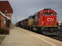 After working the yard at Sarnia, M385 with a rag tag mix of power makes their way out of the yard at Sarnia for the St.Clair Tunnel. The tunnel runs under the namesake river. Upon emergence from the tunnel on the other side M385 will be in Port Huron, Michigan for the continuance of its journey. I took this shot on the west end of the VIA Rail station platform. 