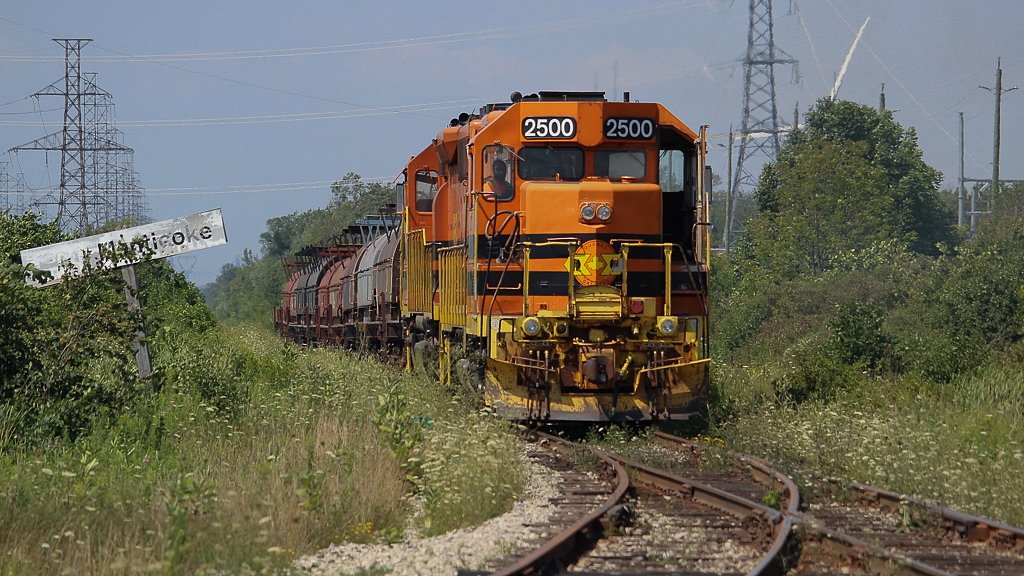 With my plans to chase GEXR today gone with this snowstorm, I thought I'd post a flashback to a hot summer's day. Humidex values were well into the 30s on this August afternoon, and just like pretty much every other day this past summer, the SOR crews had the door wide open trying to find any relief from the heat they could. I never did get to see a true Nanticoke steel train, and something like this is probably about as close as I will ever get to anything resembling one. SOR dropped the refinery traffic north of concession four for their ESSO switchers to lift, and proceeded south with QGRY 2500 and RLHH 3404 towing a string of coil cars for Stelco. The heat and sun were a bit too much this day and I called it once they entered the gates to Stelco.