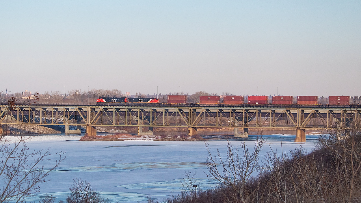 One of CN's new GEVOs is on point as 119 crosses the South Saskatchewan River on a cold November afternoon, continuing its journey westward after a brief stop in Saskatoon. Something I am sure we can all relate to: I was nowhere near this location when I heard them beginning their conversation with RTC about departing, but knew I wanted to get at least one shot on the bridge while I was there. So it was somewhat of a scramble using Google Maps on my phone to identify a spot, drive over, and then walk/run down a hilly and snow covered trail to this location. But, I made it in time, and as we all know, that's what matters most.