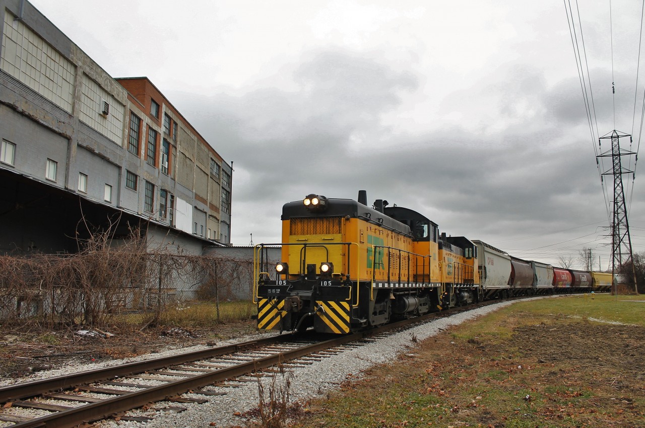 After recently taking a loaded grain train from CP, ETR wasted no time getting it out to Ojibway Yard for ADM. Here they are passing a storage warehousing facility between Crawford and Elm Avenues in West Windsor.