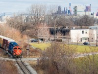 This is an angle I have done before, even recently with a <a href="http://www.railpictures.ca/?attachment_id=35697">smoky 4003</a>. However, I had yet to have a good opportunity at shots of CN since they assumed Hamilton operations from SOR on December 14 and this is one of the more noteworthy angles the N&NW has to offer with respect to stamping the location as Hamilton. Here, the 07:00 yard job has finished its work down the hole for the day and is led back to Stuart Street by 7058 - a beltpack-equipped unit. For those wondering, all of power sets for CN in Hamilton so far have been beltpack-equipped. The three boxcars upfront are from Parkdale Warehousing, and a lone tank brought up the rear. I am still adjusting to the fact that I won't find SOR switching out there in the north end anymore.