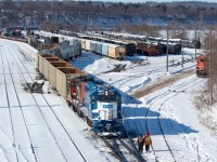 A look at Stuart Street post-CN resuming operations here. At bottom, a couple of crew members work the remote operated power outside in the bitter cold (-20C wind chill) as they switch the yard in preparation for the imminent arrival of 422 and later 331, both of which had work to do at Stuart. The switches in the yard have been cleared by crews working through the night and well into the day, after Hamilton got dumped on with over 20cm of snow. Compared with this <a href="http://www.railpictures.ca/?attachment_id=35798">shot</a> in October 2018 when SOR was switching the yard and serving the industrial customers, the yard seems much more spacious now with more room on the ladder tracks, and has looked the way for much of the time that has followed the CN takeover. The long string of hoppers (where the second from the front is blue) are Nova Chemicals hoppers which have been sitting in the yard for several weeks now; something I can't say I ever observed in the past. These hoppers are commonplace on 330/331 (for OxyVinyls east of Port Rob I believe - perhaps someone can confirm), and sometimes on 421/422 as well.