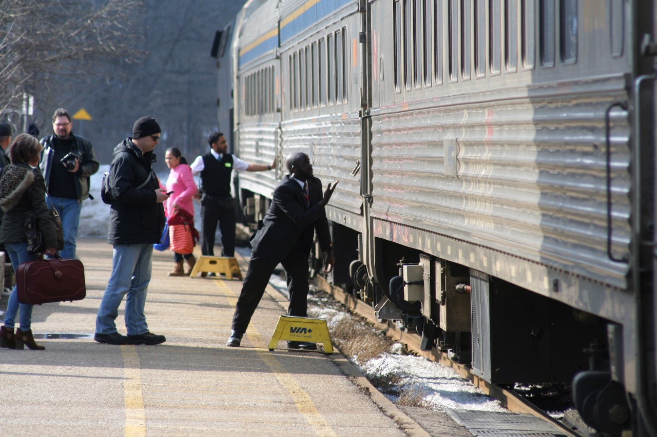 VIA Rail train #73 with 908 pauses at the station in Woodstock, Ontario as on-board employee's busily load and unload passengers before proceeding westward.