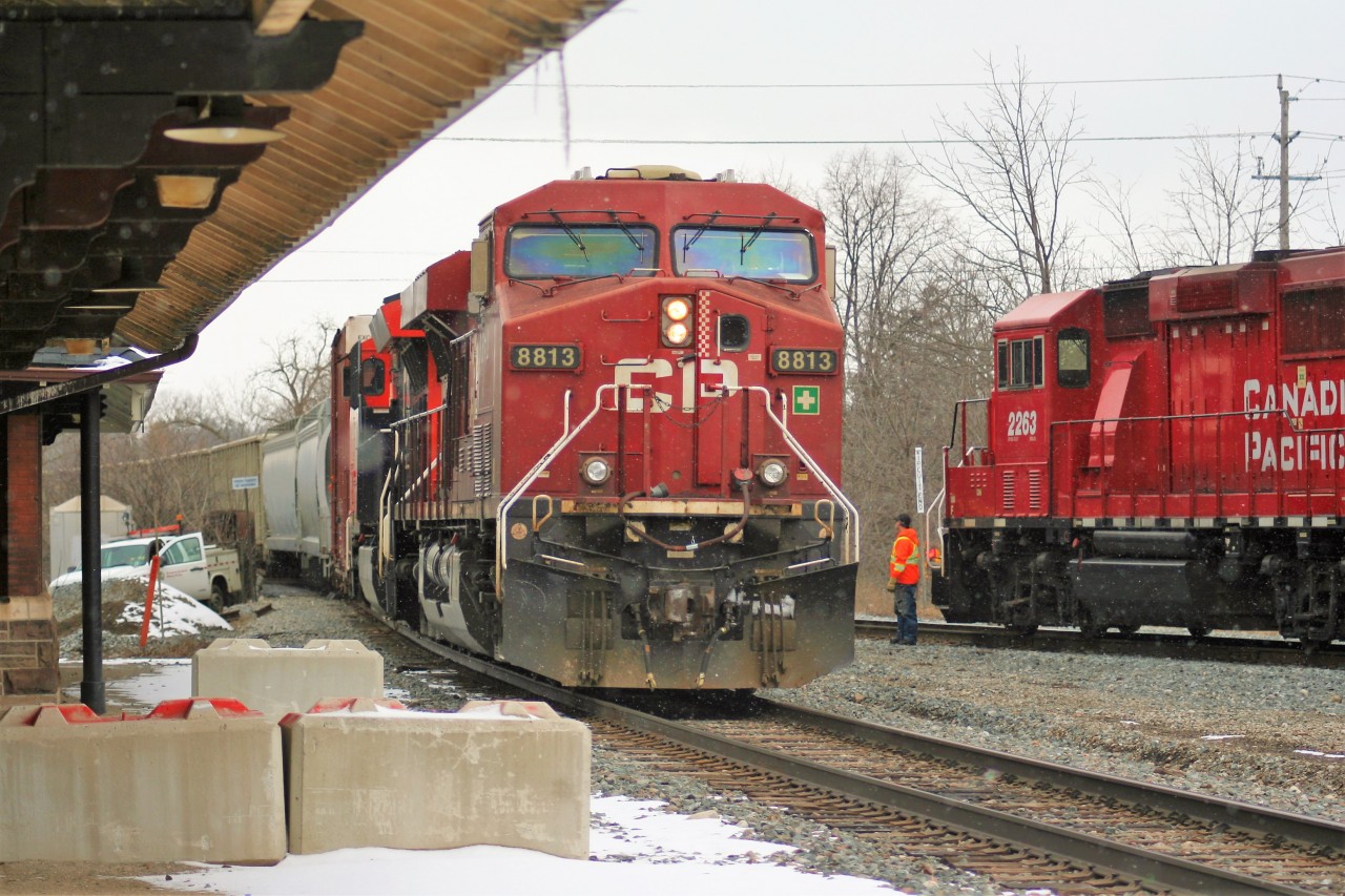As a late winter snow falls, eastbound train 254 with 8813 and CN 3026 meet the Wolverton Job with 2263, 3113 and 2270 in front of iconic Galt station.
