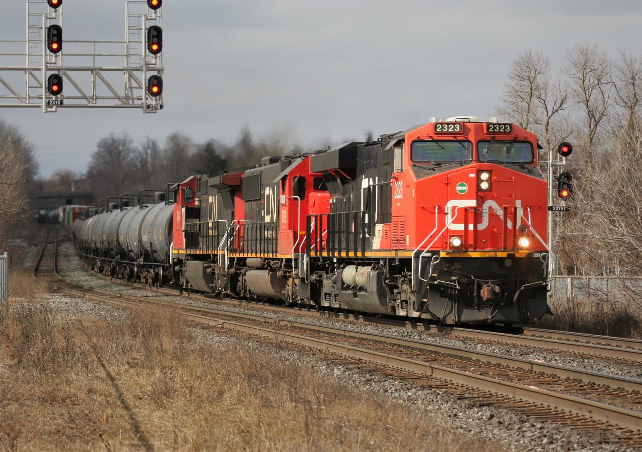 CN 2323, CN 5408 and CN 2164 lead an eastbound train through Georgetown under a lucky break in the clouds.