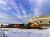 Due to some air problems at Gordon yard, CN 120 is a few hours late in leaving. Once they've departed, they're seen here, passing the new Evens Center in downtown Moncton, New Brunswick. 