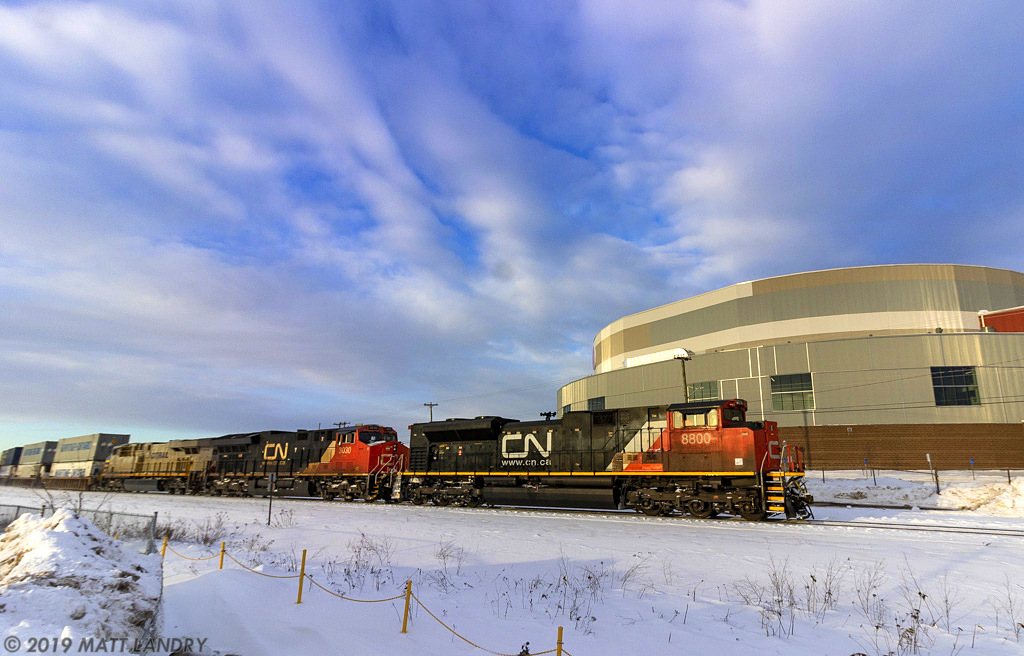 Due to some air problems at Gordon yard, CN 120 is a few hours late in leaving. Once they've departed, they're seen here, passing the new Evens Center in downtown Moncton, New Brunswick.