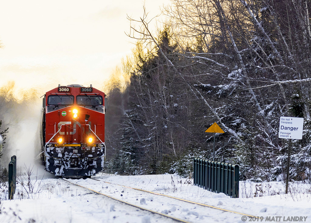 After sunrise, CN 3060 leads 848 axle empty potash train B731, as they head through Berry Mills, New Brunswick on a cold January morning.