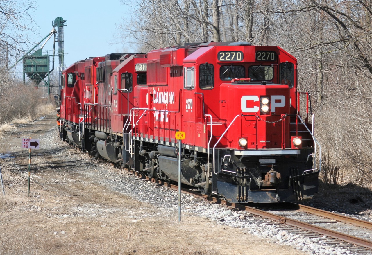 CP GP20C-ECO 2270, GP38-2 3113 and GP20C-ECO 2263 are seen on the Ayr Pit Spur in Ayr, Ontario during a late winter afternoon. The trio had reversed down to the FS Partners/Growmark facilities to lift several awaiting hoppers cars. However, upon arrival they found an unmanned track mobile blocking the hoppers. So with nobody there to move the track mobile they retreated light power back up to the Galt Subdivision and to their home base at the Wolverton yard.
