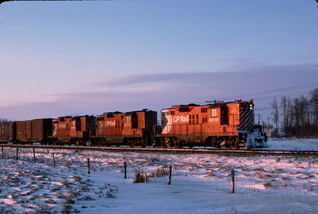 Here is an oldie...we left for a day of railfanning in Calgary and caught this NB freight just outside Wetaskiwin.  I was in the back seat of a two door car and the guys in front bailed and left the car rolling. I eventually extricated myself and got this picture.  Back in those days, geeps were the normal power on Calgary / Edmonton trains.