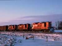 Here is an oldie...we left for a day of railfanning in Calgary and caught this NB freight just outside Wetaskiwin.  I was in the back seat of a two door car and the guys in front bailed and left the car rolling. I eventually extricated myself and got this picture.  Back in those days, geeps were the normal power on Calgary / Edmonton trains.