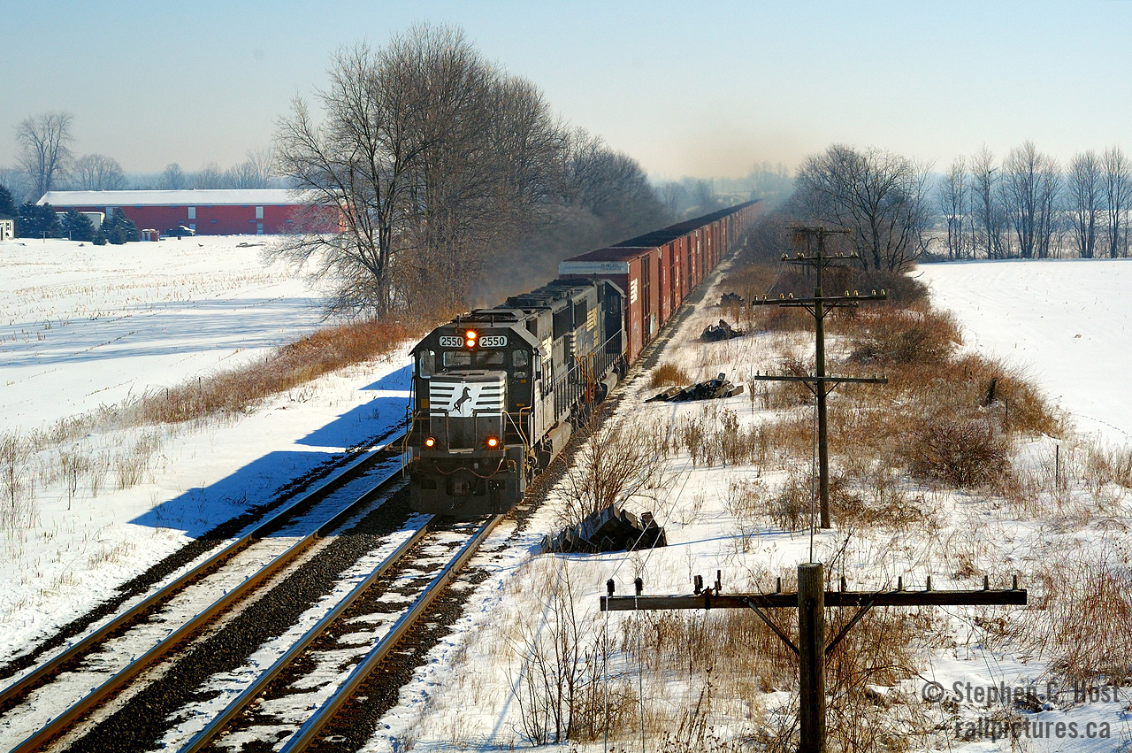 The lens of time and optics can reveal interesting facets in your photographic journey, 15 years ago I spent a beautiful sunny spring day with a friend photographing trains, got a few keepers and a few misses, but at Blenheim Rd I waited here for NS 327 to pass by with a pair of standard cab EMD units. In the optics of time, there's considerable haze in the distance owing to the increased pollution we put up with. And of course, NS trains in Ontario are basically gone. The village of Canning is in the far left corner.