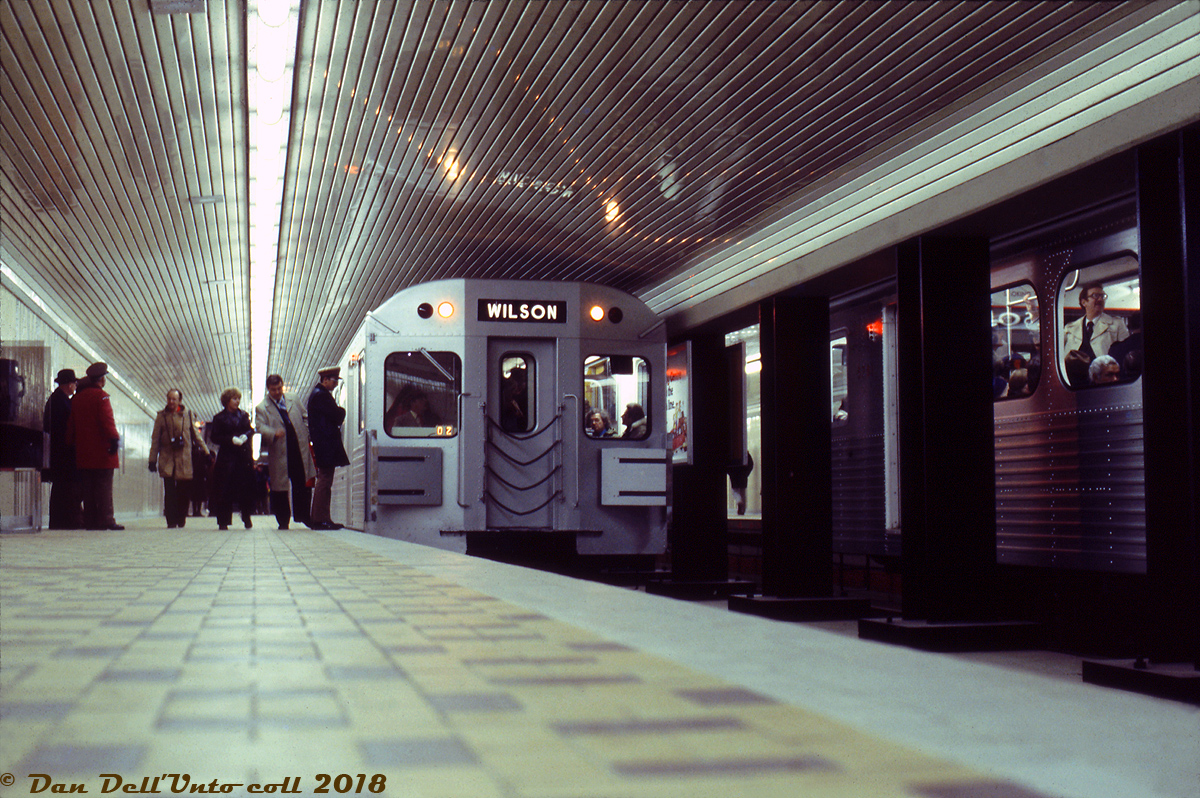 In late January of 1978, work was finally completed on Toronto's new Spadina Subway extension (from St. George to Wilson Station), and it was officially opened for regular operations with an opening day ceremony on January 27th 1978. According to Transit Toronto's Spadina extenion history page, opening day featured two trains running north and south from St. Andrew and Wilson subway stations, meeting at St. Clair West subway station where attendees were subject to speeches and a tour of the new station facilities (which included the subway platform level, and an underground bus & streetcar terminal under St. Clair Avenue). The next day, regular operations began with free rides for all passengers that day.

During opening day ceremonies, we find the northbound train of new Hawker Siddeley H5's posed at the northbound platforms of St. Clair West Subway Station, with another H5 train stopped on the southbound side (on closer observation, the number on one of the cars appears to be 5741). TTC supervisors and employees (note caps and jackets) crowd around the front end. The fellow in the brown coat with the camera is likely the late Robert McMann, who was also in attendance for the opening day. He was a well-known local TTC fan who shot many slides of the system from the early 1960's and into the early 90's.

J. Bryce Lee photo, Dan Dell'Unto collection slide.