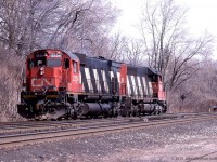 CN 5185 (SD40) and CN 2334 (M636 "Big Alco") are running light at mileage 0 on the north track of the Dundas Sub, where it joins the Oakville Sub at CN Bayview. <br> CN 2334 appears to have white class lights and headlights on, but the ditch lights don't seem to be, and the cab of CN 5185 is visibly occupied. Looks to me like the engines are eastbound with CN 5185 leading.