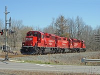 GP20c-eco locomotives CP 2211 and CP2292 with GP38-2 CP 7307 in the middle (formerly D&H, ex-Lehigh Valley) are southbound at Parkside Drive grade crossing in Waterdown.  They are returning light after helping northbound train CP 142 uphill from Hamilton to Waterdown North. According to www.cpr.ca  "Facts about CP in Hamilton"  <br>
The grade to the north is the second steepest mountain grade on CP's network (including the Rockies) and is six miles long from Hamilton to Waterdown.
